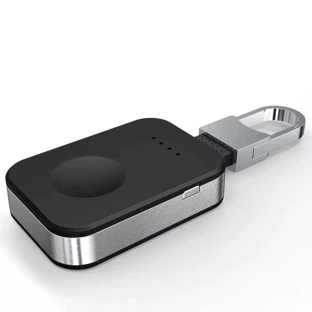 Black Apple Watch portable wireless power bank on a keyring showing compact size.