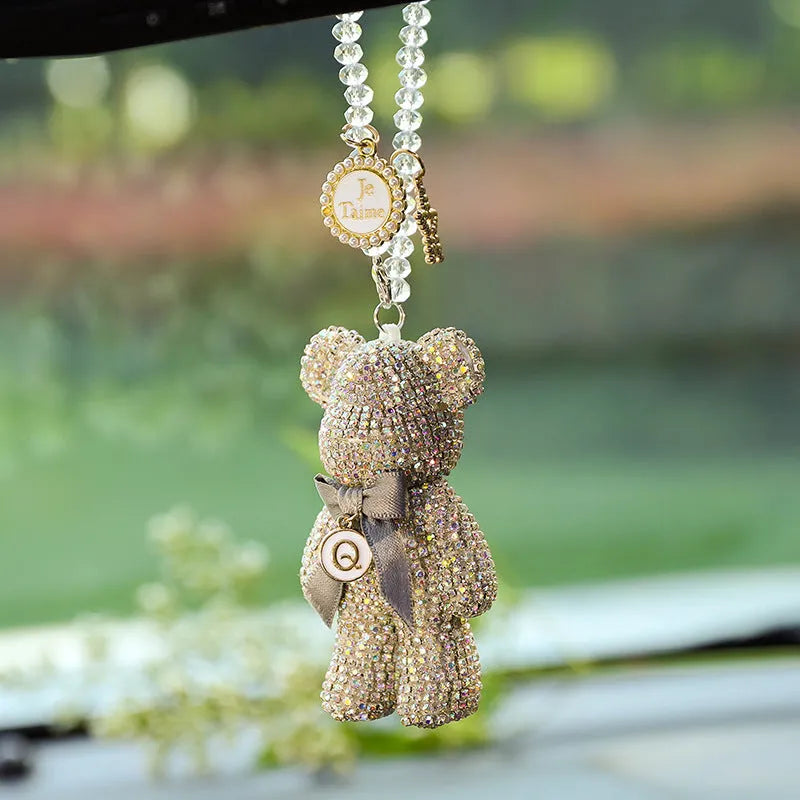 Black violent bear car mirror pendant with embedded crystal rhinestones on a white background.