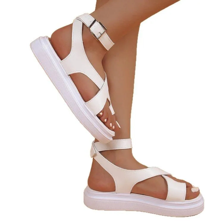 Women's white thick-soled Roman-style sandals with a buckle and loop-foot strap on a composite sole.