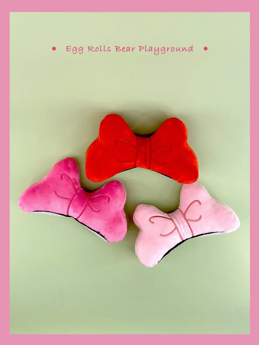 Soft plush bow tie decoration for helmets in red, peach pink, and rose pink colour options.