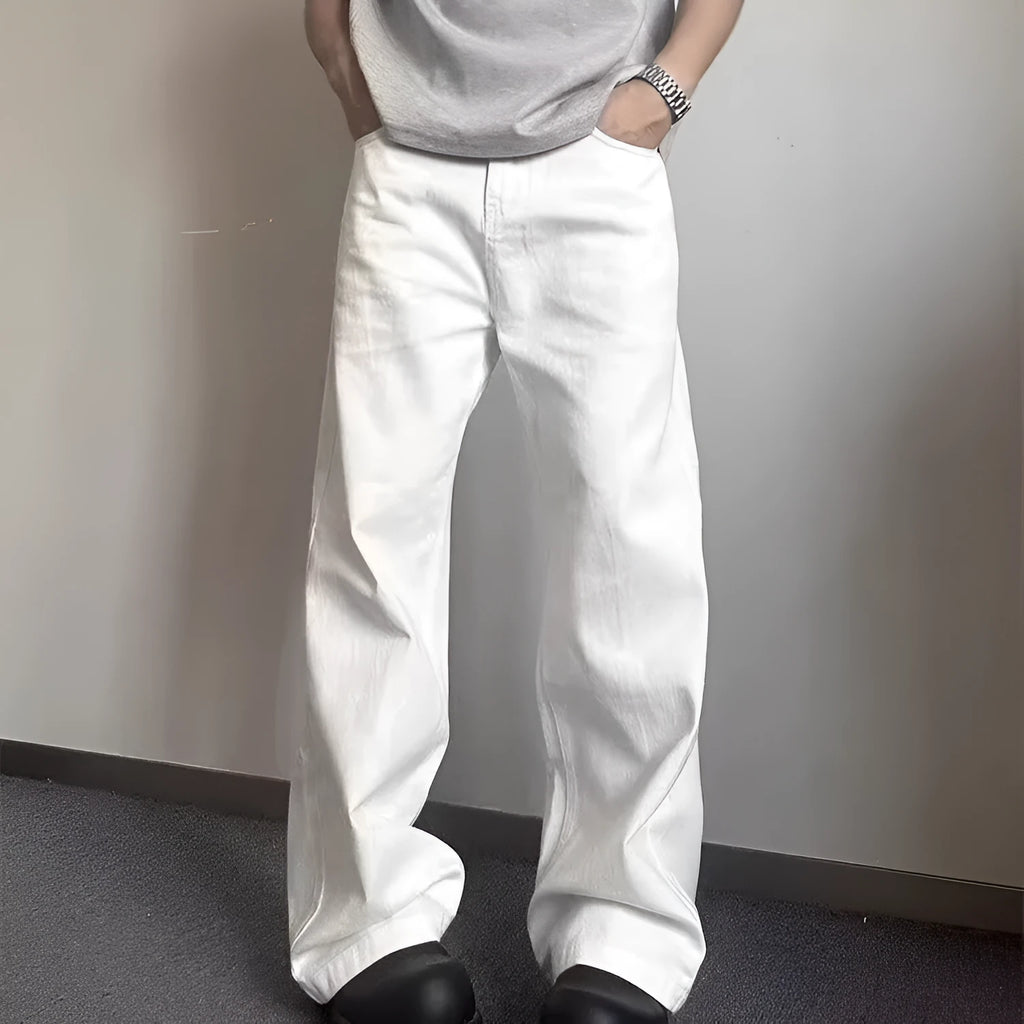Man wearing white straight-leg cotton denim jeans with a wide leg opening.