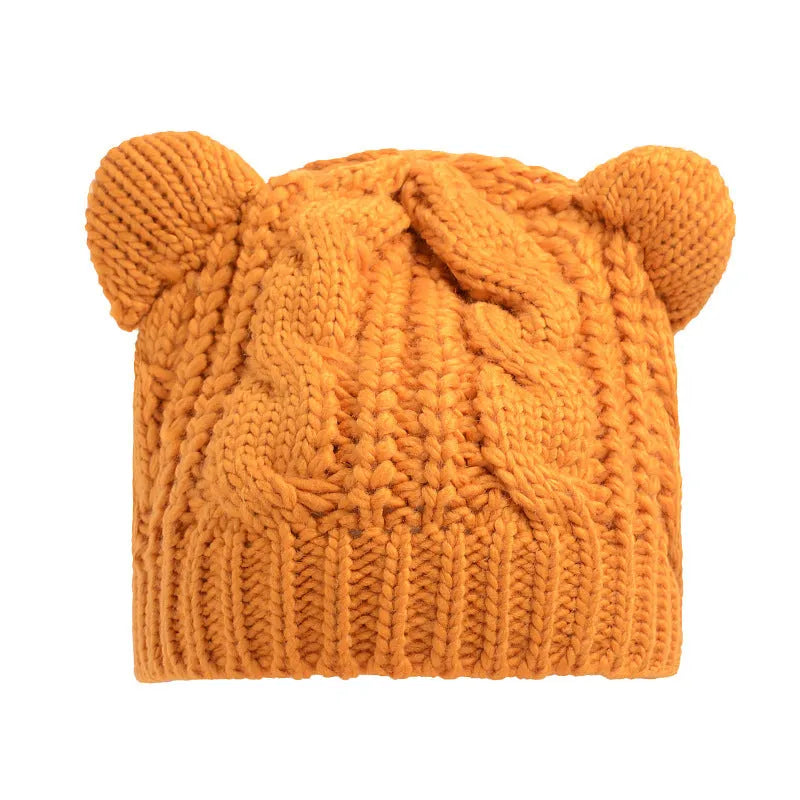 Hand knitted red wool beanie with 3D cat ears on a white background