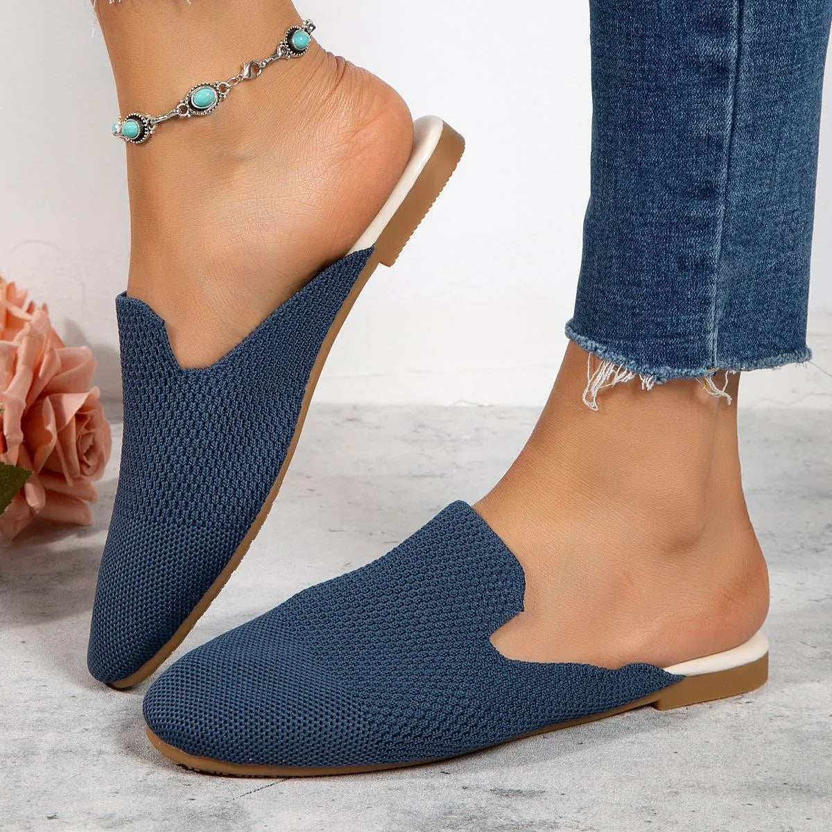 Apricot coloured mesh slip-on sandals with a round toe and flat rubber sole on a white background