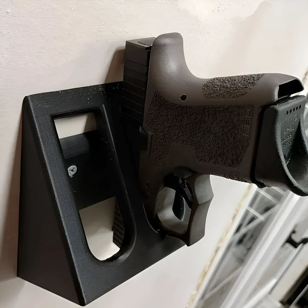 Black punk-style plastic pistol stand for displaying an airsoft gun.