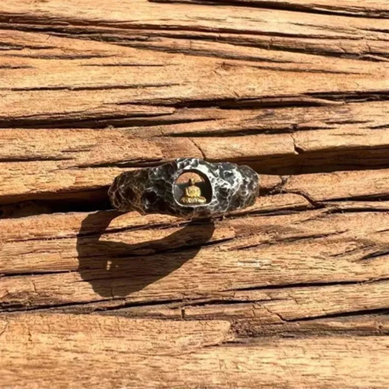 Hand-forged copper grotto Buddha ring with a rock texture finish, shown in size 8.