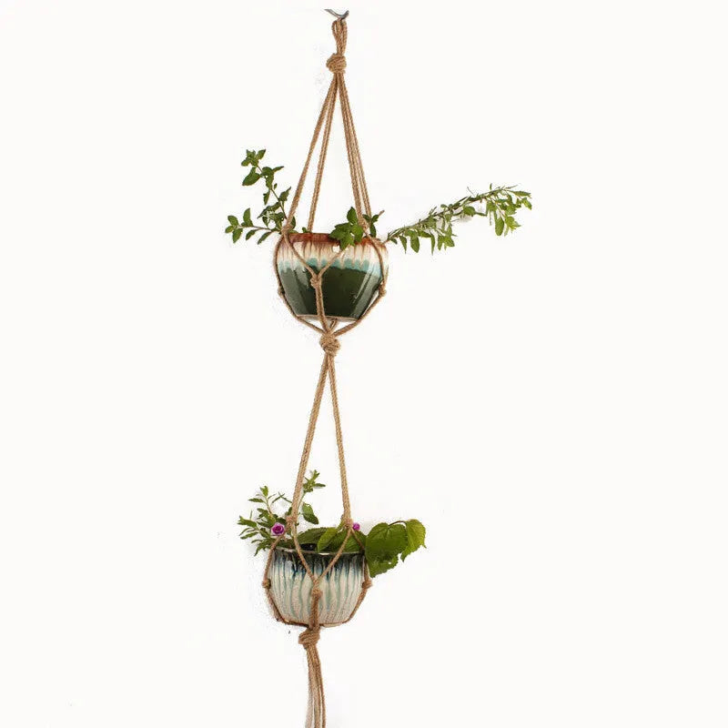 A rustic-style woven cotton rope plant trellis panel supporting green leaves.