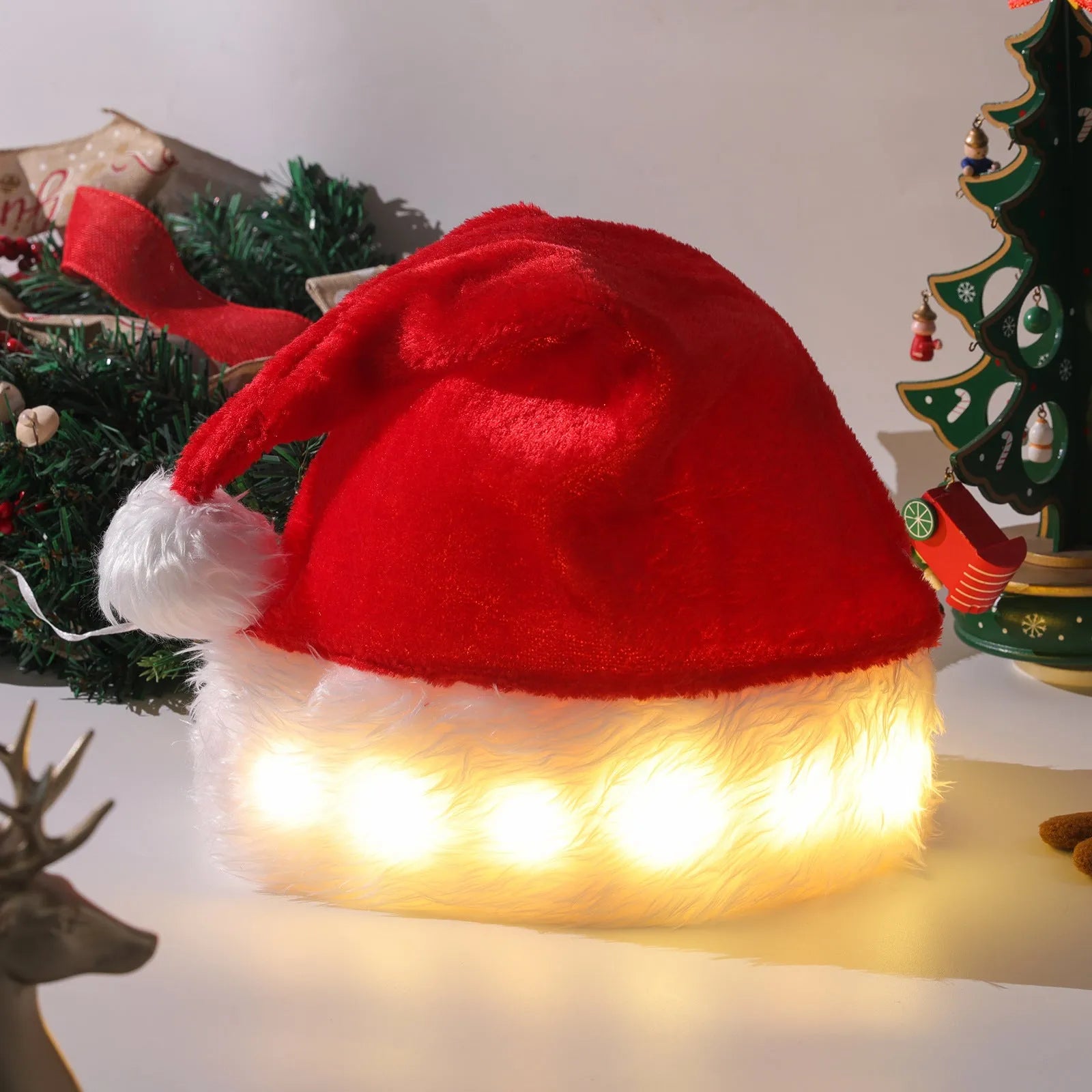 Red and white plush Santa hat with integrated multi-colour LED lights glowing