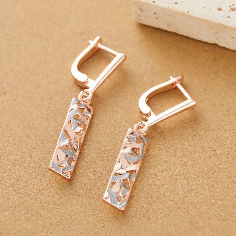 A pair of rectangular two-tone hollow stud earrings with an electroplated picture-style finish.