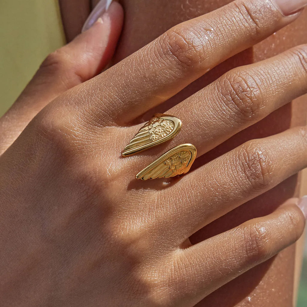 Stainless steel adjustable wings ring with an opening design in a gold-tone finish.