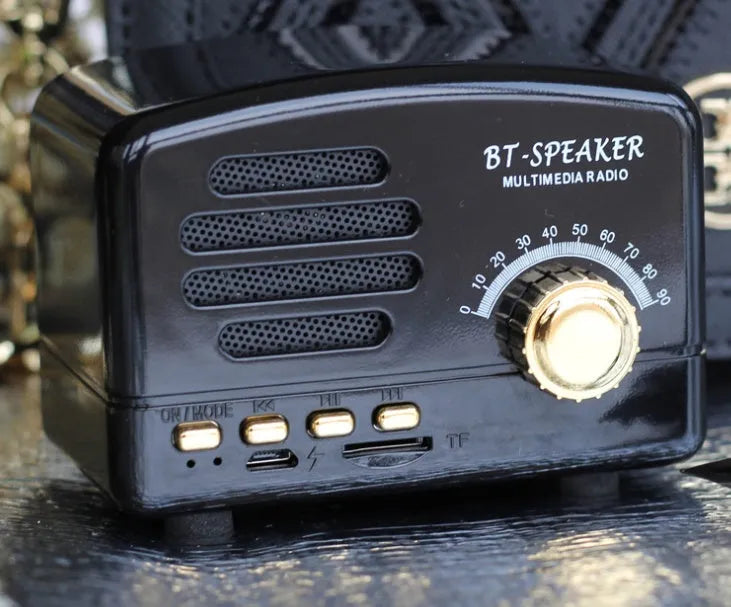 Vintage wood grain Bluetooth speaker with compact design and USB charging cable