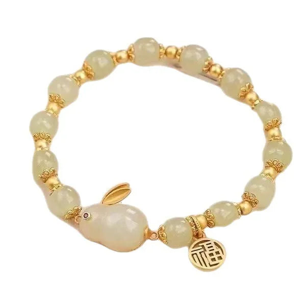 Green lucky bracelet with fu character charm, jade hare charm, and black bracelet base
