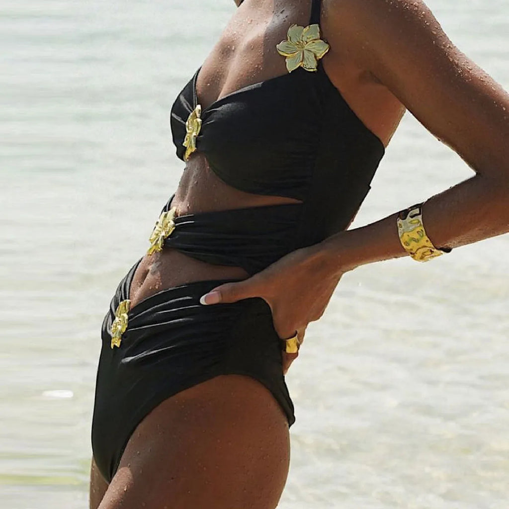 Women's solid colour one-piece swimsuit with hollow-out tube top and matching short skirt on hanger.