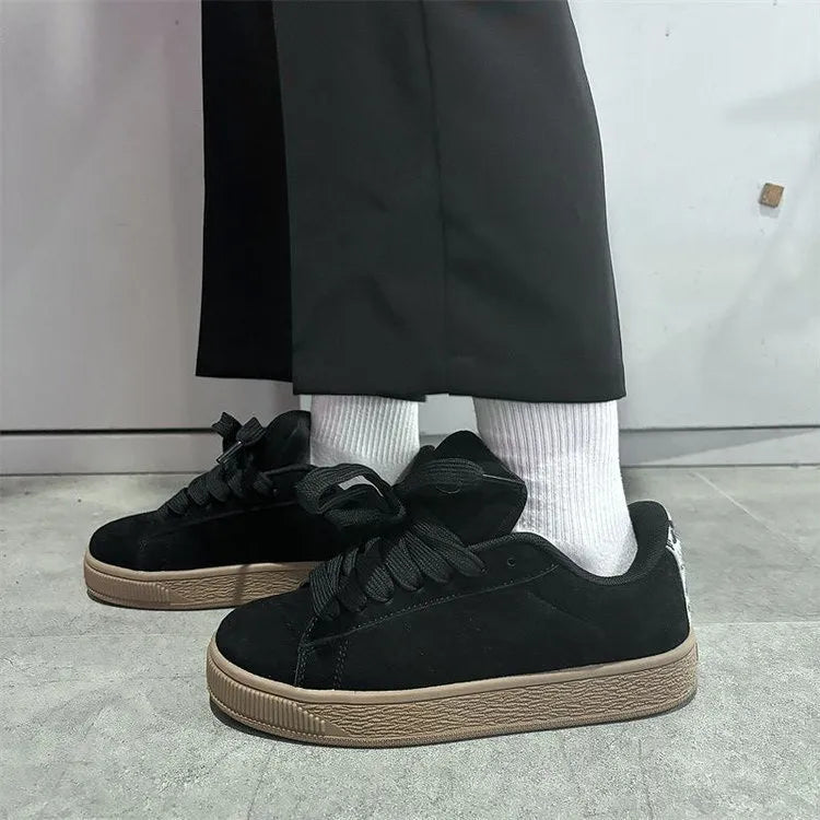 Retro black low-top sneakers on a waterproof platform sole with round toe and lace-up front.