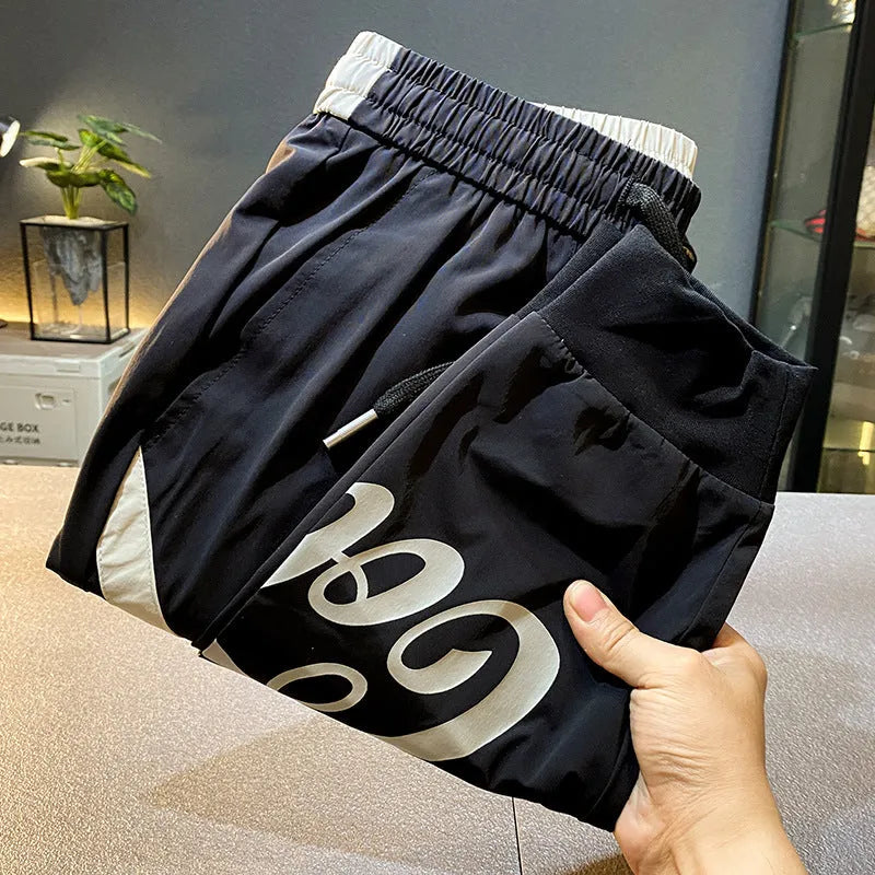 Men's black ankle band trousers with cropped casual fit in lightweight ice silk cotton fabric