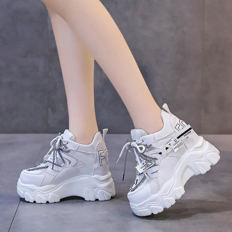 White women's low-top platform sports shoes with a cross-strap and breathable mesh upper on a rubber sole.