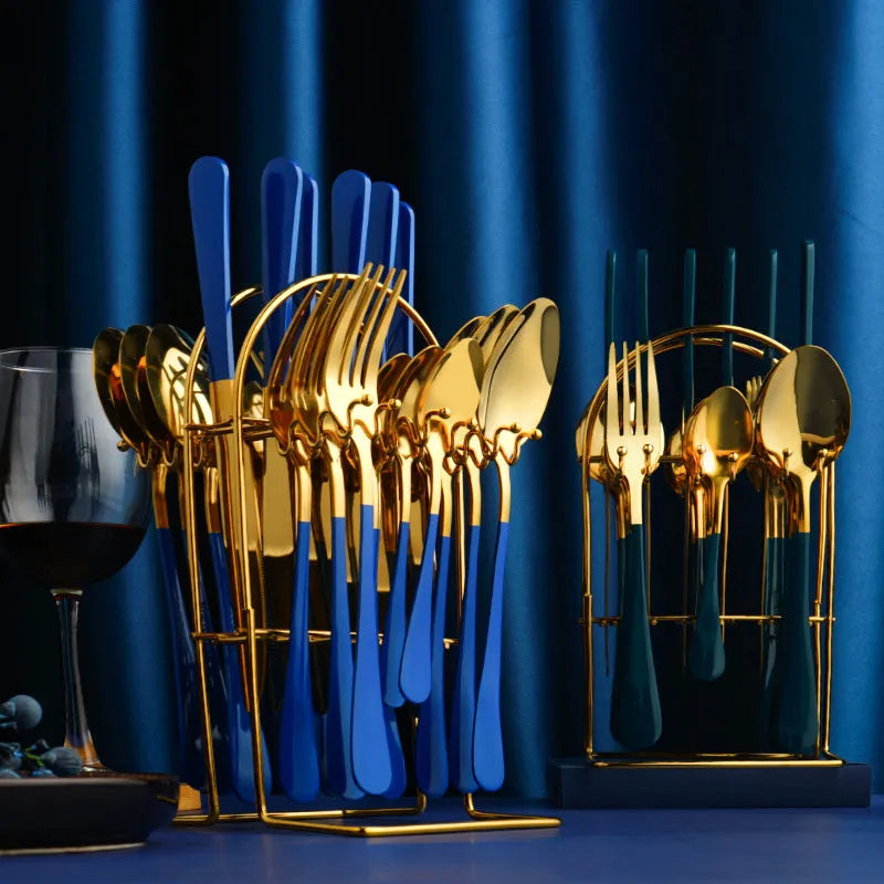 24-piece stainless steel cutlery set with knives, forks, spoons and teaspoons on a storage rack.