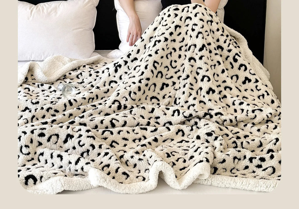 Double-layer cationic leopard jacquard taffeta blanket showing reversible design with zebra pattern