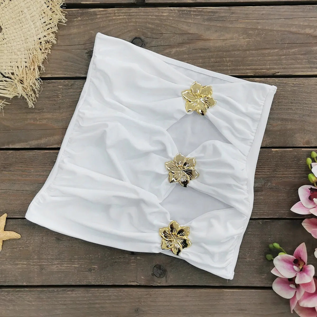 Women's solid colour one-piece swimsuit with hollow-out tube top and matching short skirt on hanger.