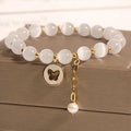 White cat's eye crystal bracelet with geometric design on a wrist