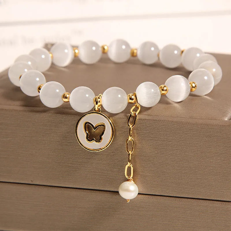 White cat's eye crystal bracelet with geometric design on a wrist