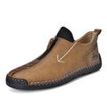 Men's black leather ankle boots with a front zip and hand-stitched detailing on a rubber sole.