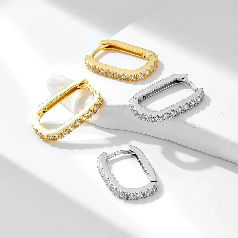 Sterling Silver oval geometric zircon ear clip earrings for women on a white background.