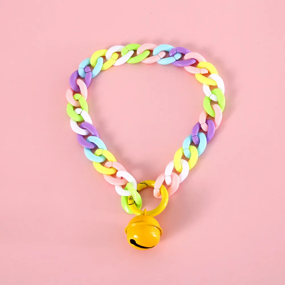 Adjustable plastic pet collar in macaron candy colours with chain detailing, shown with a buckle.