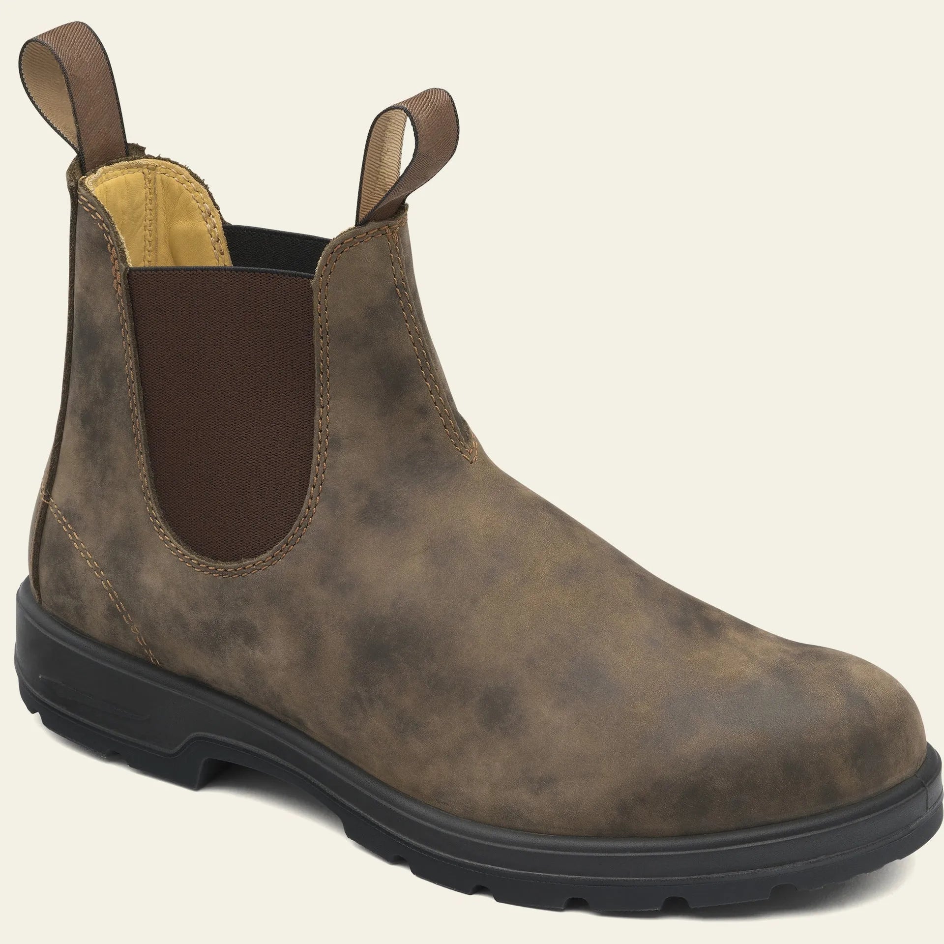 Vintage brown unisex Chelsea boot with frosted PU upper and car suture detailing on a wooden floor.
