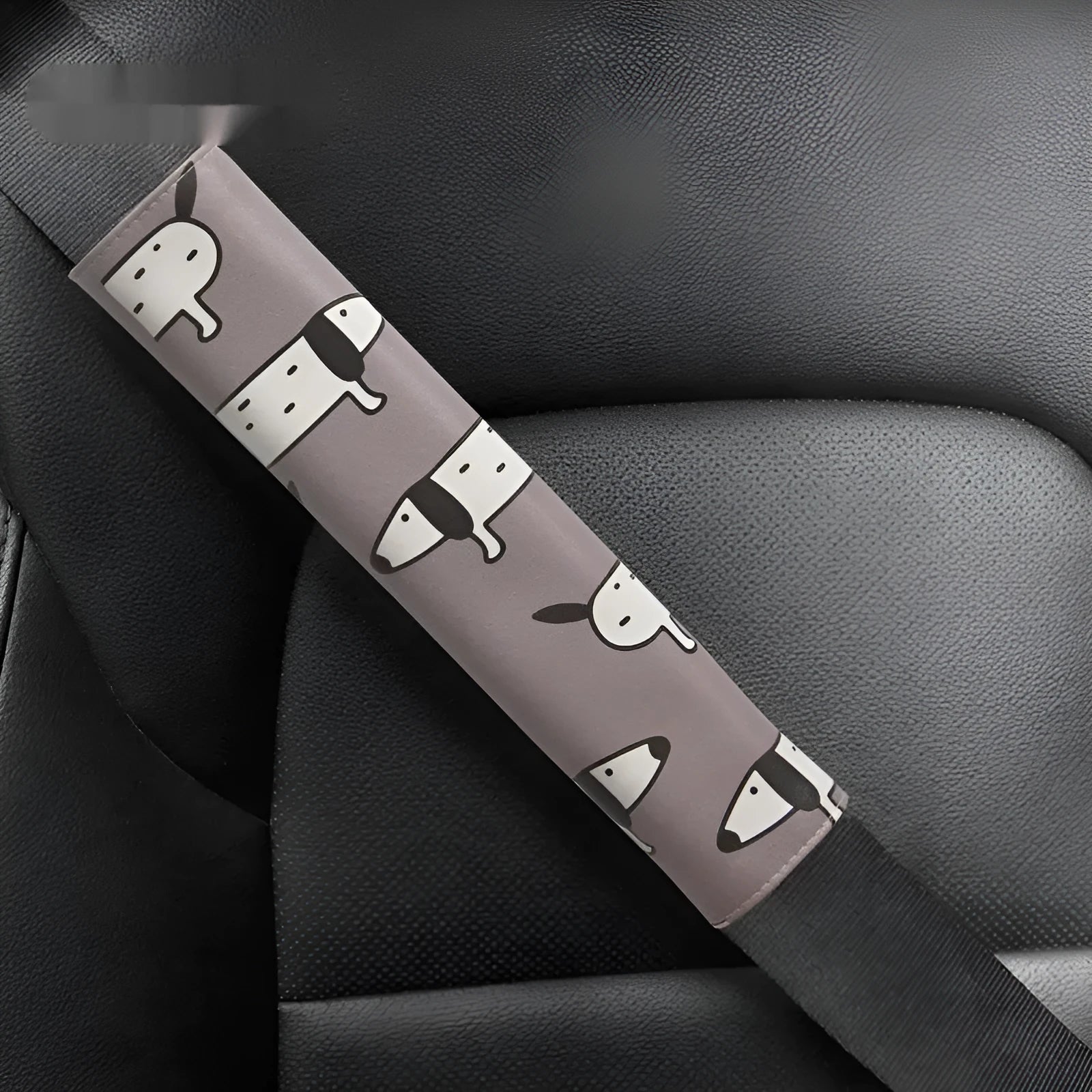 Cute Dachshund cartoon design on a black PU leather car seat belt shoulder protector sleeve.