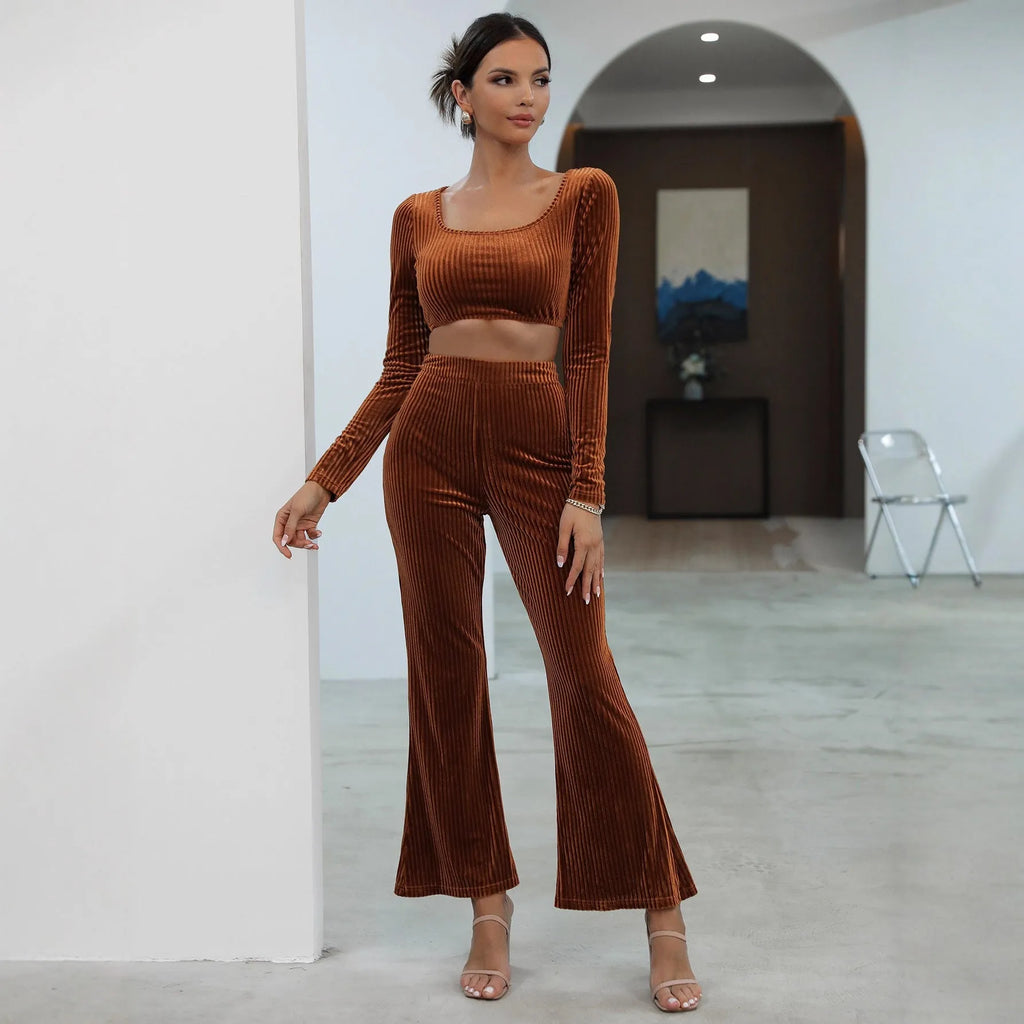 Caramel coloured long sleeve sweater and straight-leg trousers set on a hanger