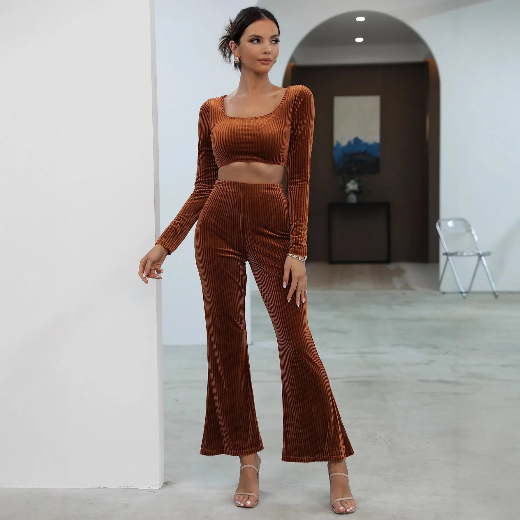 Caramel coloured long sleeve sweater and straight-leg trousers set on a hanger
