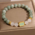 Women's oil green emerald crystal bracelet with five-piece sutra design on wrist.