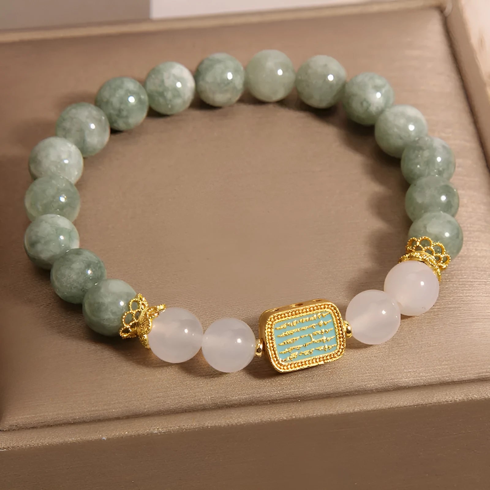 Women's oil green emerald crystal bracelet with five-piece sutra design on wrist.