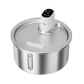 Stainless steel pet water fountain with a white heating base on a kitchen counter.