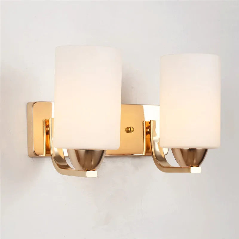 A modern chrome wall lamp with a clear glass shade, shown in single-head and double-head styles.
