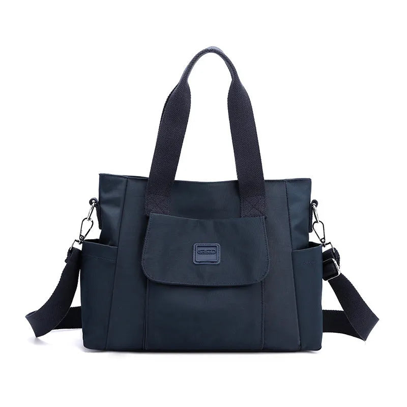 Women's large capacity multi-interlayer shoulder bag in nylon, soft horizontal square shape with sewing line detail, multiple internal compartments, urban simplicity style