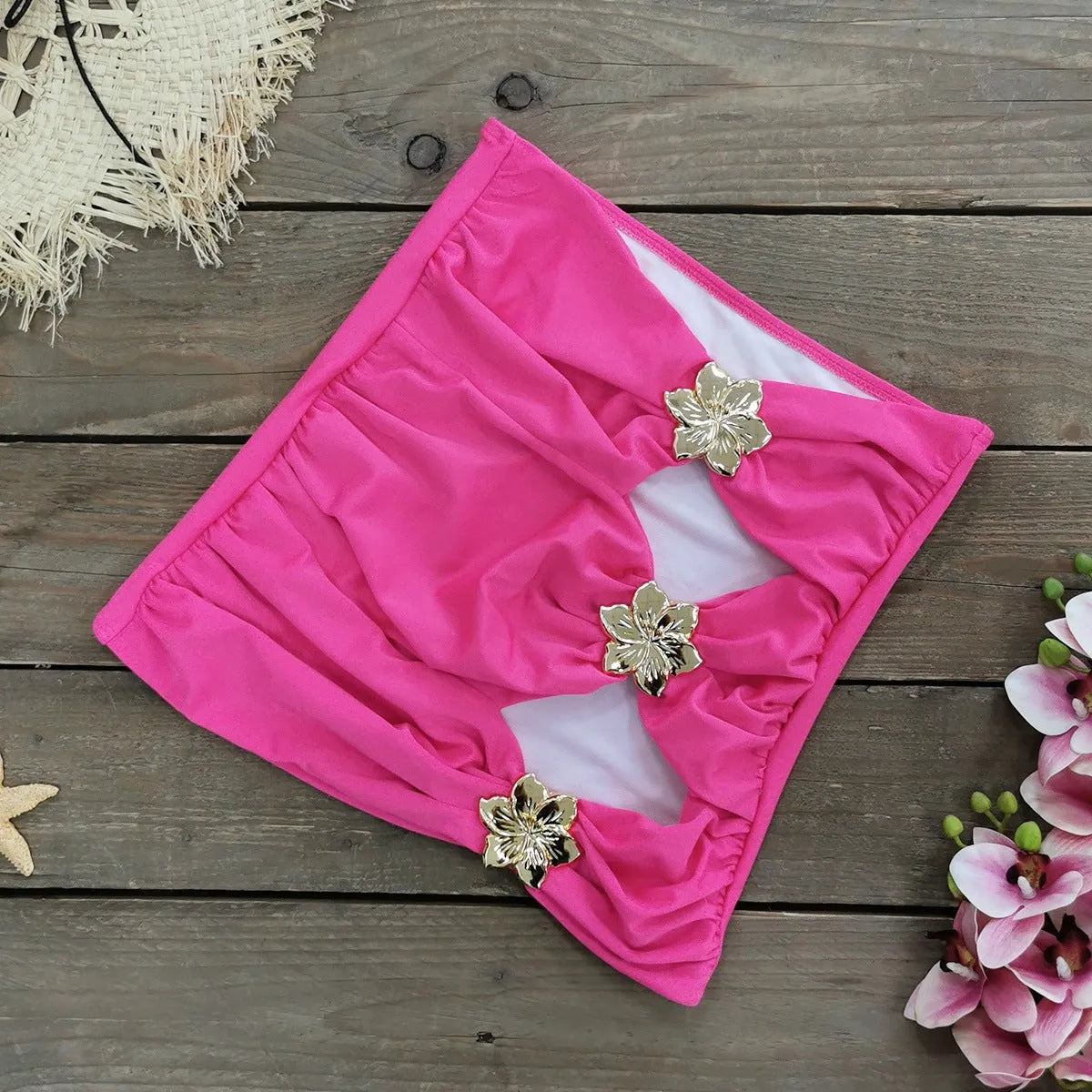 Women's solid colour one-piece swimsuit with hollow-out tube top and matching short skirt on hanger.