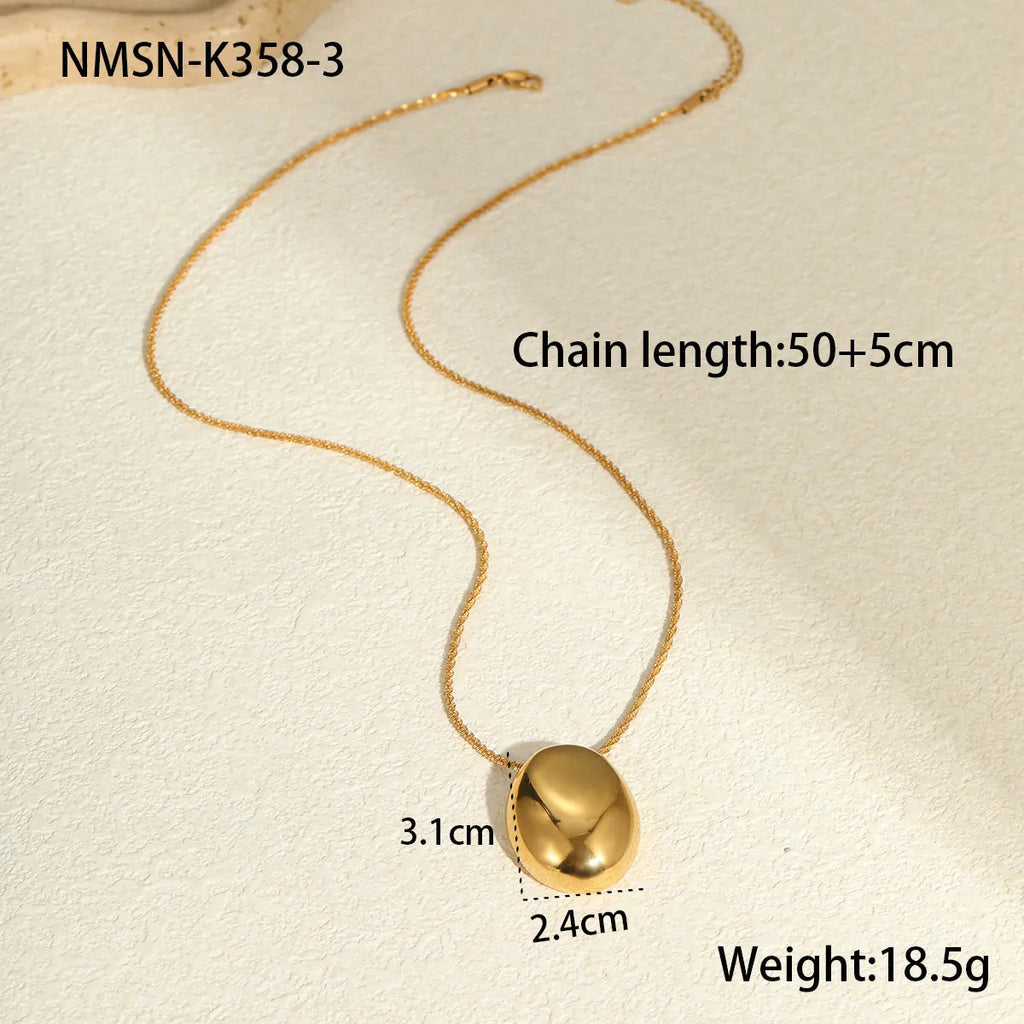 Gold geometric pendant necklace with adjustable chain on plain background