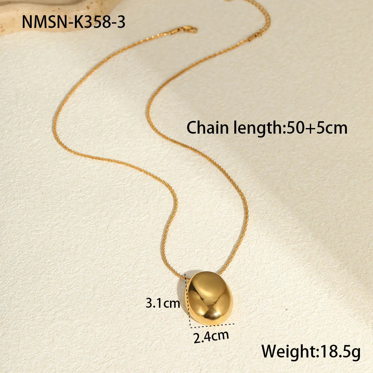 Gold geometric pendant necklace with adjustable chain on plain background