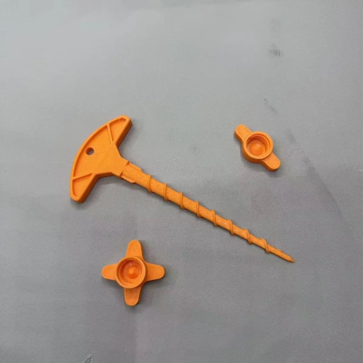 3D-printed PLA sealant nozzle cap set with two corner pieces, four corner pieces, and an unclogger