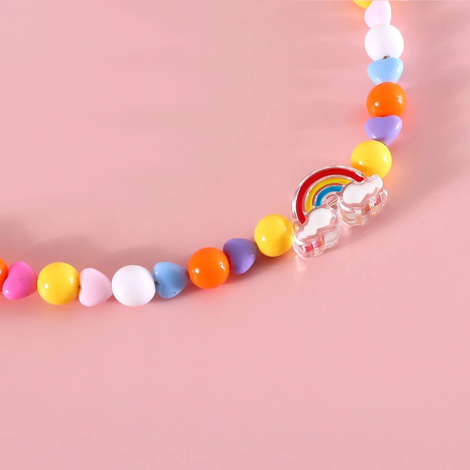 Colourful plastic bead pet necklace in small flower, rainbow, or peach design on an adjustable collar