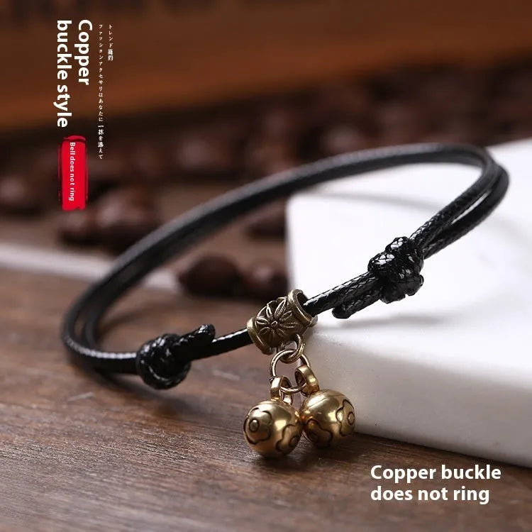 A nylon rope dog collar with a brass buckle shown alongside a version with a brass bell, in black, red, and coffee colours.