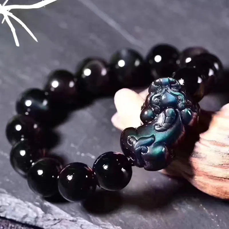 Natural ice colour eye obsidian crystal bracelet with spherical beads on a string.