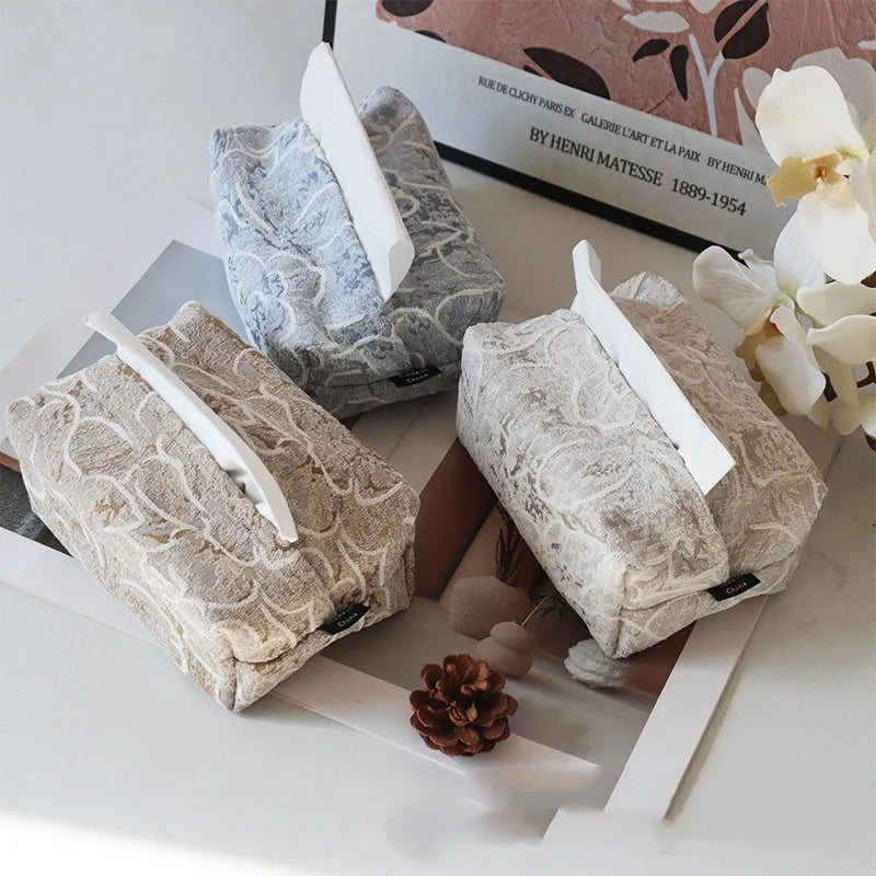 Chinese style floral cotton tissue box cover in beige, blue, and brown on a wooden table.