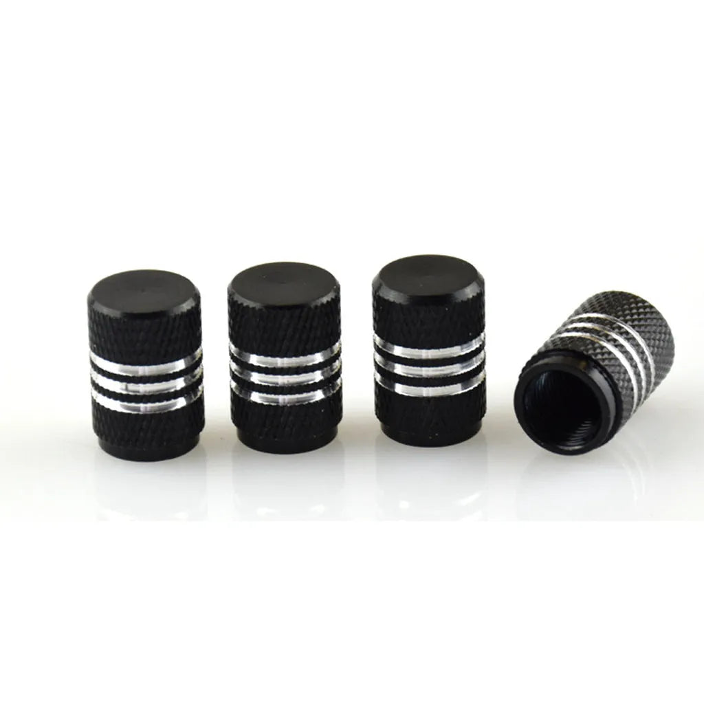 Assortment of aluminium alloy car tyre valve caps in ten different colours on a grey background.