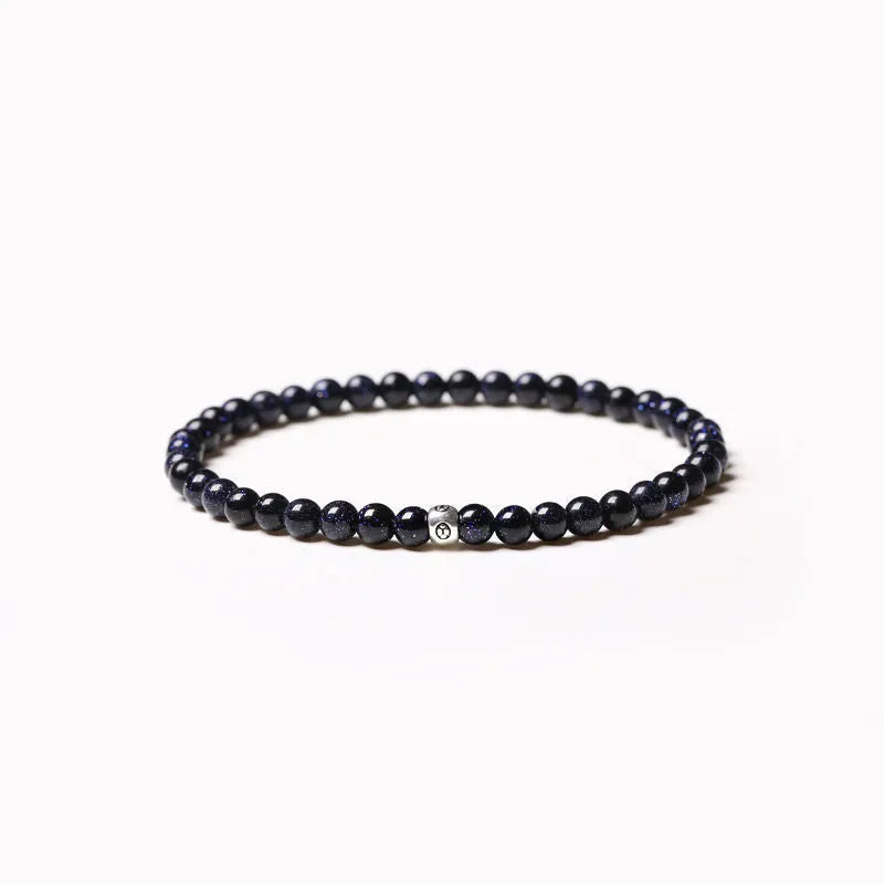 Geometric unisex bracelet with 4mm black agate, blue san, and obsidian beads on a wrist.