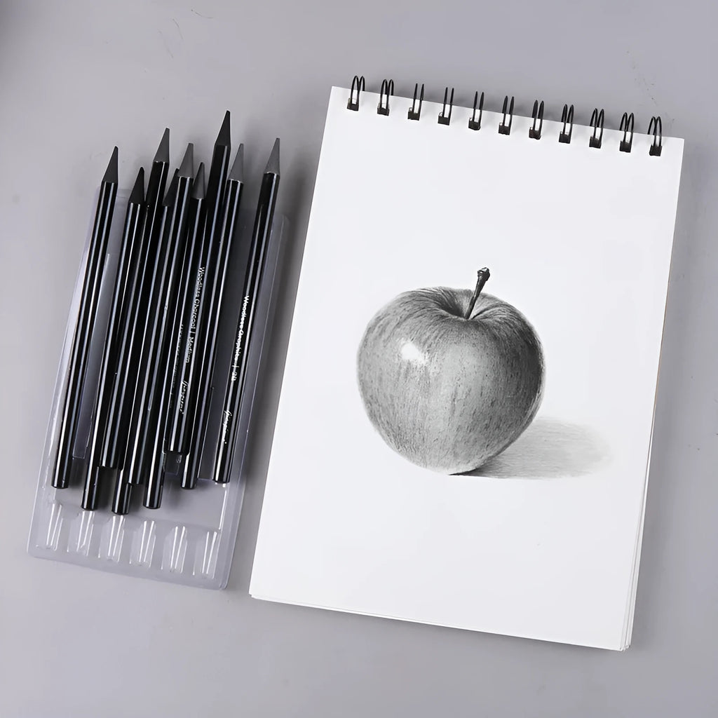 Set of six graphite and three carbonised art pencils in suction card packaging.