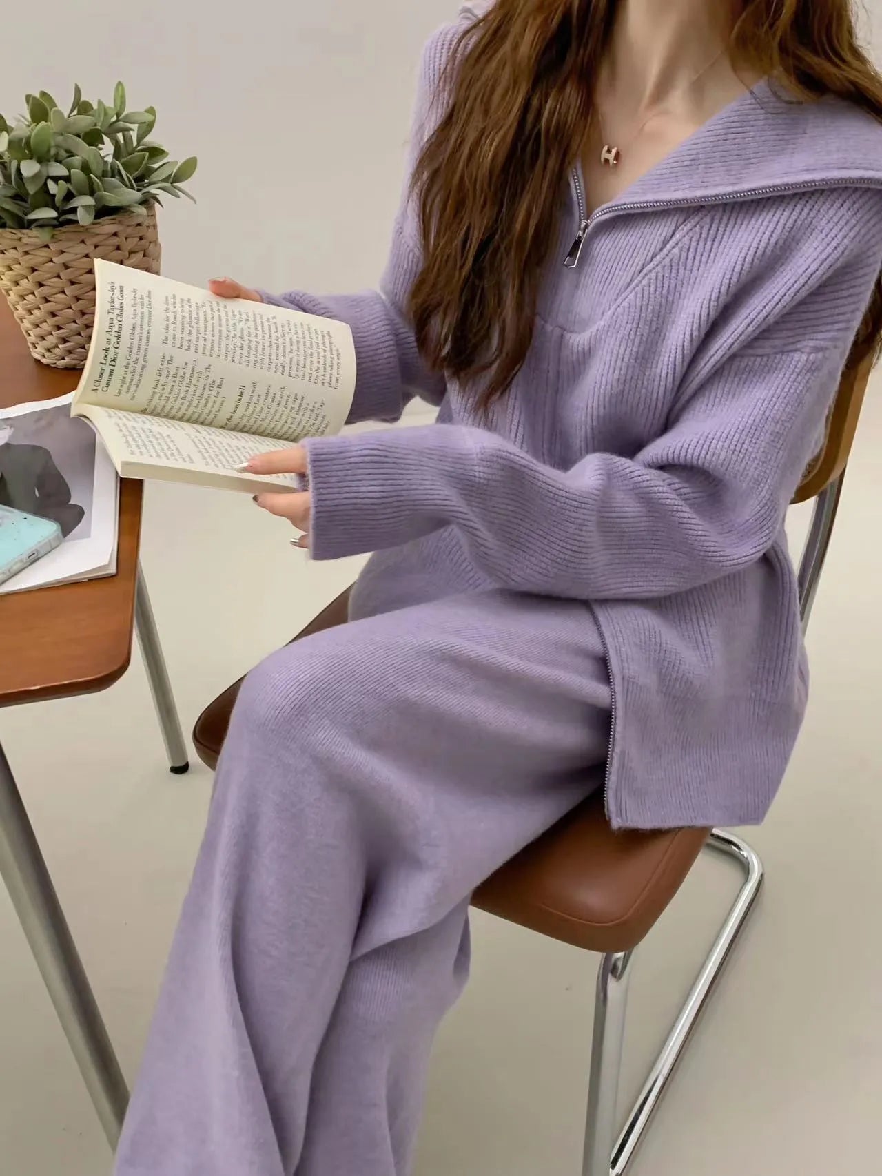 Women's knitted polyester two-piece set with zipper cardigan and wide-leg trousers in a solid colour.