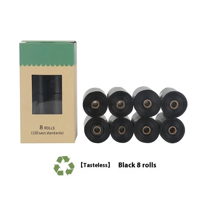 A roll of green EPI degradable pet waste bags next to a black dispenser on a grass background.