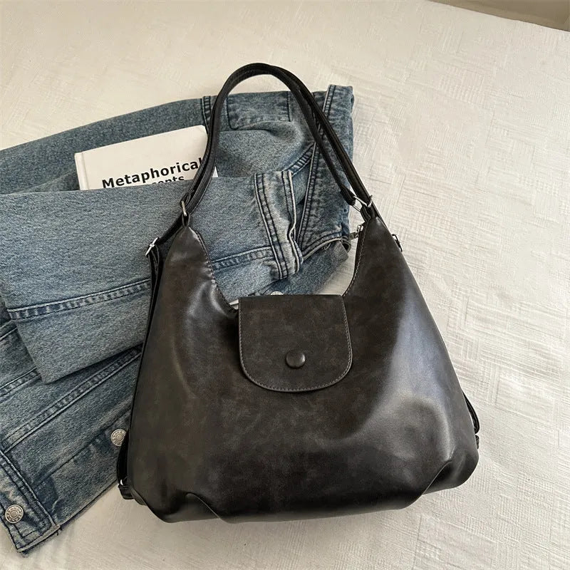 Women's PU leather shoulder bag with single strap, horizontal square design, and internal phone pouch in black colour